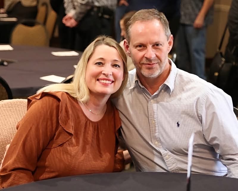 Brian and Raven Kirkley, owners of MeetUps Event Center, smiling together inside an event setting